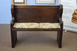 Late 19th century dark oak small church pew or hall seat, scroll shaped sides, 107cm wide