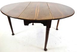 Georgian oak oval drop leaf dining table raised on tapering legs with pad feet, 110cm wide