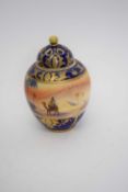 Noritake vase and cover with a desert landscape scene within gilt and blue borders, 14cm high