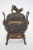 Oriental incense burner and cover raised on four feet, the vase with an impressed design of birds in