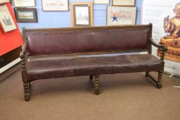 Victorian oak framed railway bench with upholstered seat and back, raised on bobbin turned legs,