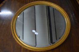 20th century circular bevelled wall mirror in a gilt finish frame, 50cm wide
