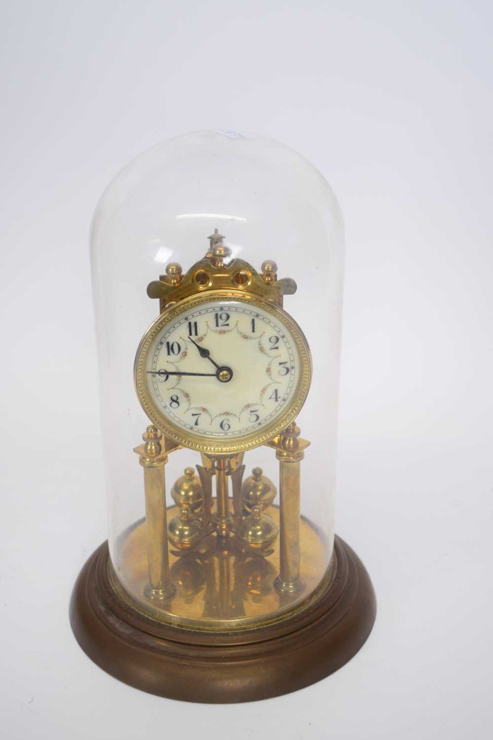 Early 20th century brass torsion or anniversary clock under a glass dome, 30cm high max