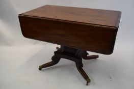 George IV mahogany Pembroke table with drop leaves and single end drawer raised on a square column