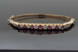 18ct gold ruby and diamond hinged bracelet, the top section alternate set with seven graduated round