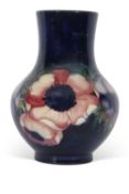 Moorcroft vase with tube lined decoration of anemones on a blue ground, 18cm high