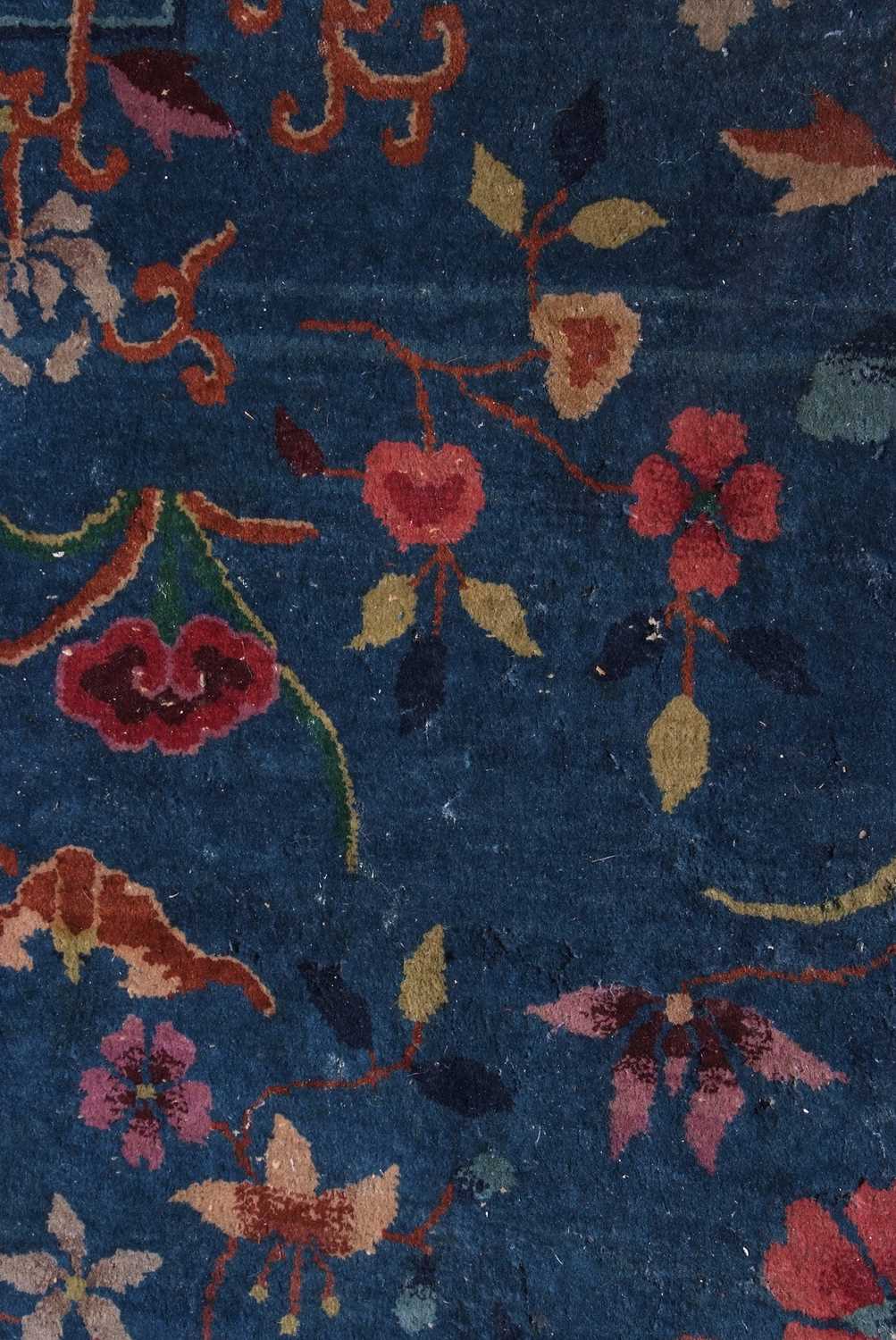 Early 20th century Peking wool carpet decorated with stylised foliage on a blue centre with a pale - Image 5 of 11