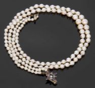 Double row of graduated cultured pearls, 3-7mm diam, to a garnet and seed pearl set clasp, 20cm long