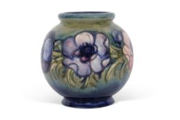 Mid-20th century globular Moorcroft vase decorated with tube lined anemones on a green ground,