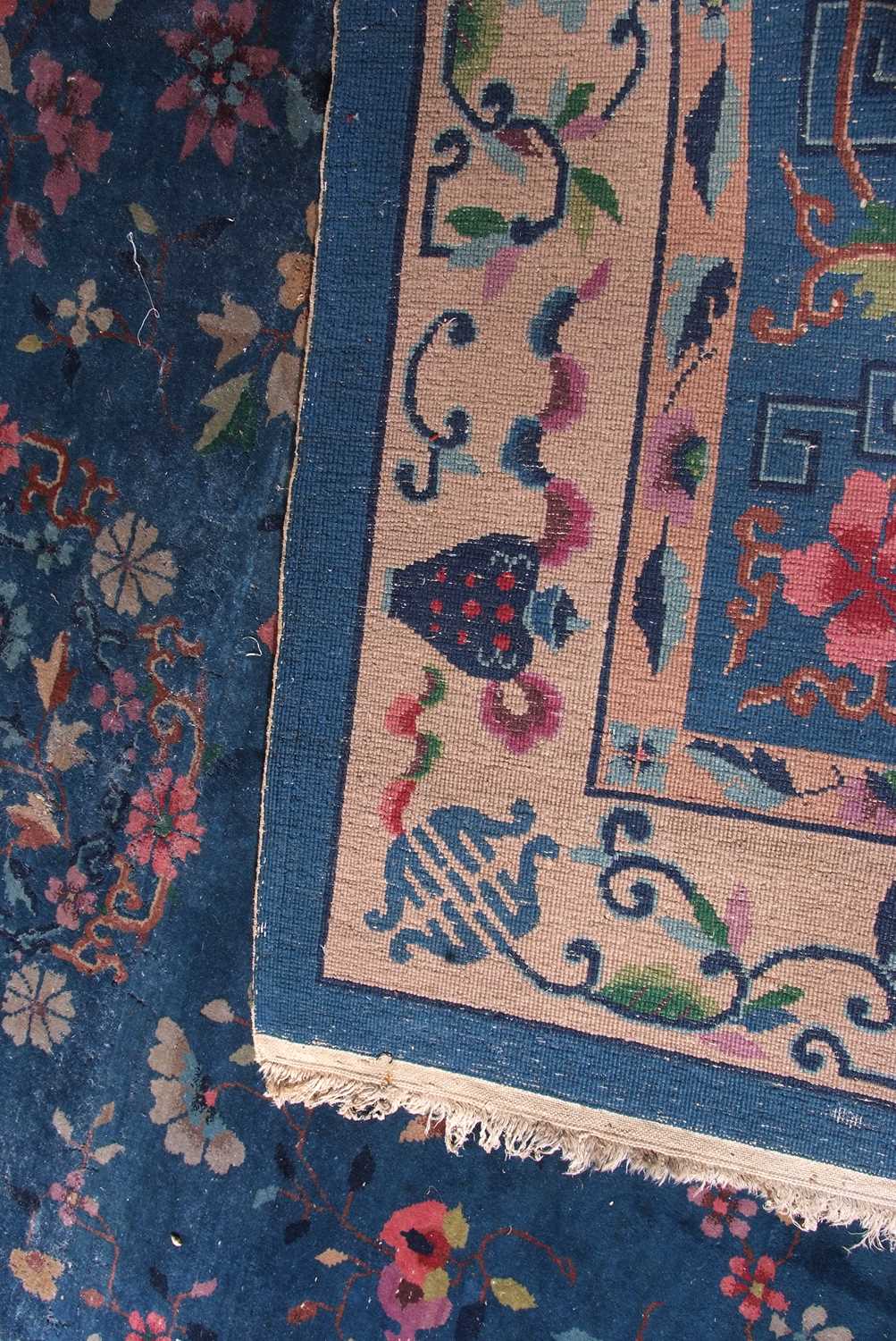 Early 20th century Peking wool carpet decorated with stylised foliage on a blue centre with a pale - Image 11 of 11