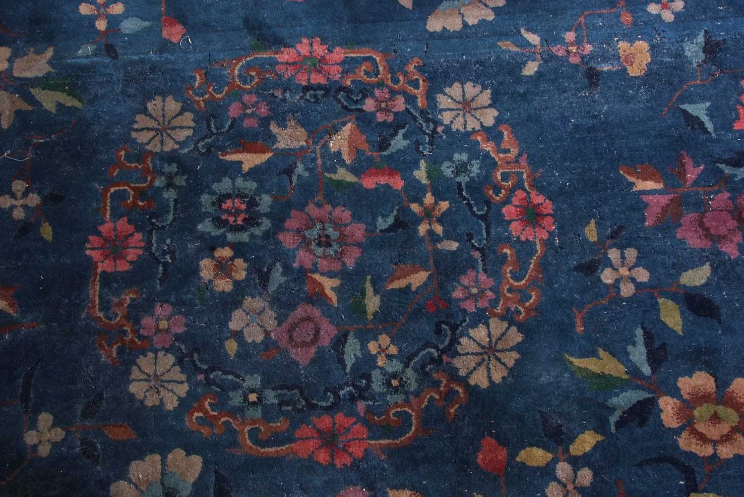 Early 20th century Peking wool carpet decorated with stylised foliage on a blue centre with a pale - Image 4 of 11