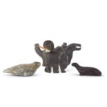 Group of Inuit sculptures including one of an Inuit hunter with spear and two further models of