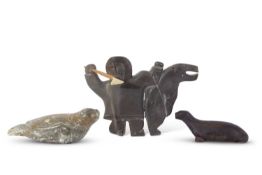 Group of Inuit sculptures including one of an Inuit hunter with spear and two further models of