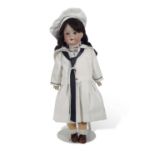 Doll dressed in naval uniform by Strobel & Wilken & Co, with bisque head and composition body,