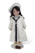 Doll dressed in naval uniform by Strobel & Wilken & Co, with bisque head and composition body,