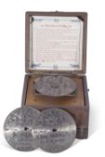 A small late 19th century Fairy polyphon in stained wooden case, complete with box of metal discs,