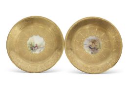 Pair of Royal Worcester plates, both with gilt designs and central panel decorated with ducks by M