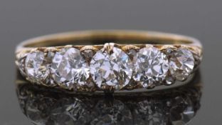 Victorian five stone diamond ring featuring five graduated old round cut diamonds, highlighted