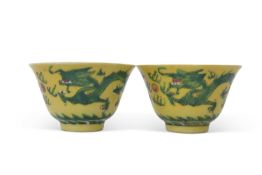 Pair of small Chinese bowls, the yellow ground decorated in famille vert enamels with dragon chasing