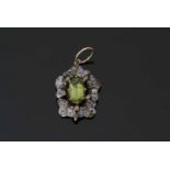 Peridot and diamond pendant centring an oval faceted peridot, 11.03mm x 6.09mm, within a mixed old