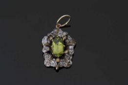 Peridot and diamond pendant centring an oval faceted peridot, 11.03mm x 6.09mm, within a mixed old