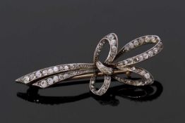 Antique diamond brooch, a tied ribbon design and set throughout with small graduated mixed old cut