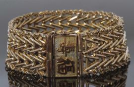 Mid-grade yellow metal articulated bracelet, the clasp with a Chinese character mark, stamped 14k,