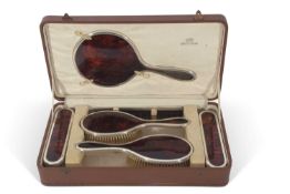 George V silver and tortoiseshell backed dressing table set of plain design comprising hand