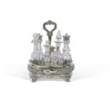 Victorian silver cruet stand of oval shape with wavy rim embossed with floral and foliate designs