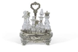 Victorian silver cruet stand of oval shape with wavy rim embossed with floral and foliate designs