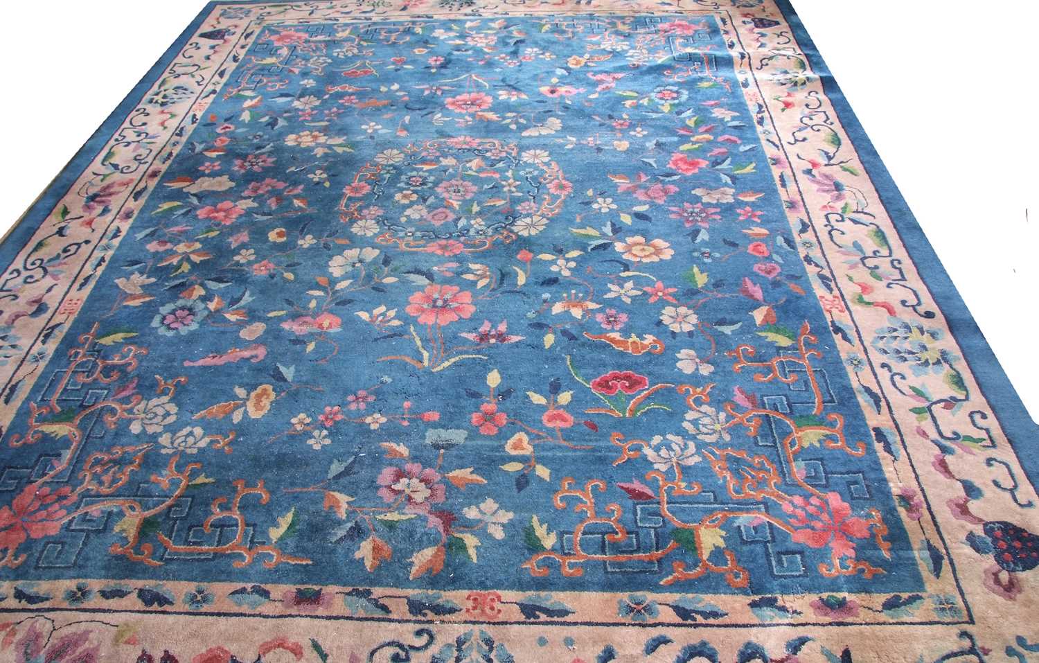 Early 20th century Peking wool carpet decorated with stylised foliage on a blue centre with a pale - Image 2 of 11