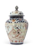 Japanese Arita porcelain jar and cover decorated with a geisha with gilt mons on blue ground,