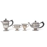 George V Irish silver tea set of circular baluster form with applied banded Celtic decoration,