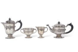 George V Irish silver tea set of circular baluster form with applied banded Celtic decoration,