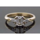 Three-stone diamond ring, the centre set with an emerald cut diamond, 5.38 x 4.02 x 2.61mm,