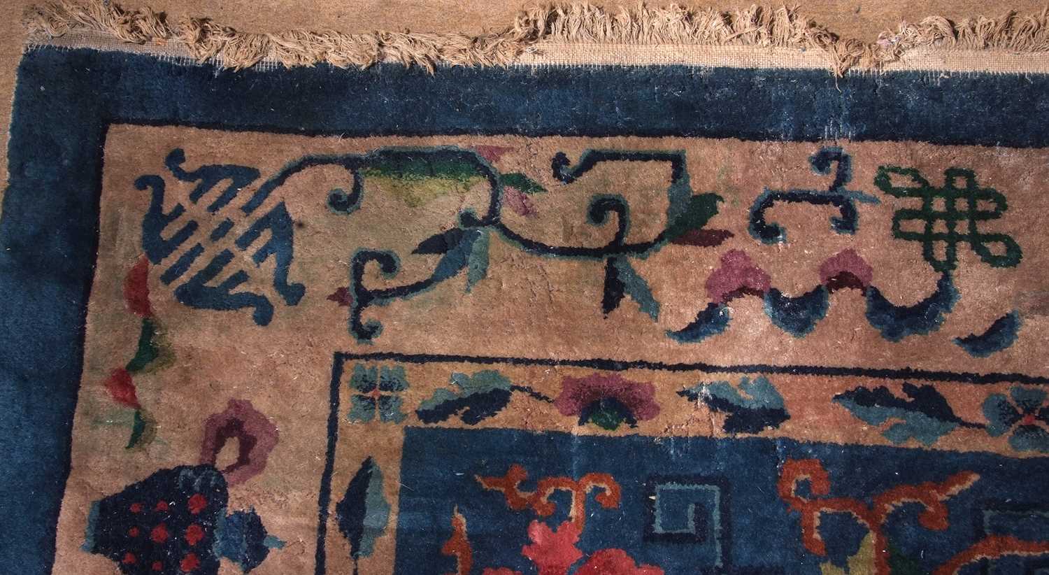Early 20th century Peking wool carpet decorated with stylised foliage on a blue centre with a pale - Image 7 of 11