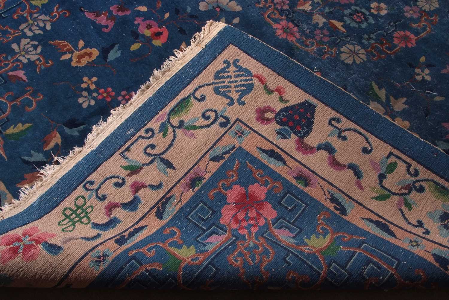 Early 20th century Peking wool carpet decorated with stylised foliage on a blue centre with a pale - Image 9 of 11