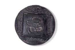Chinese circular black slate inkwell and cover modelled as a sinuous dragon, the cover with dragon