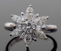 Precious metal diamond star cluster ring centring a round brilliant cut diamond of 0.30ct approx,