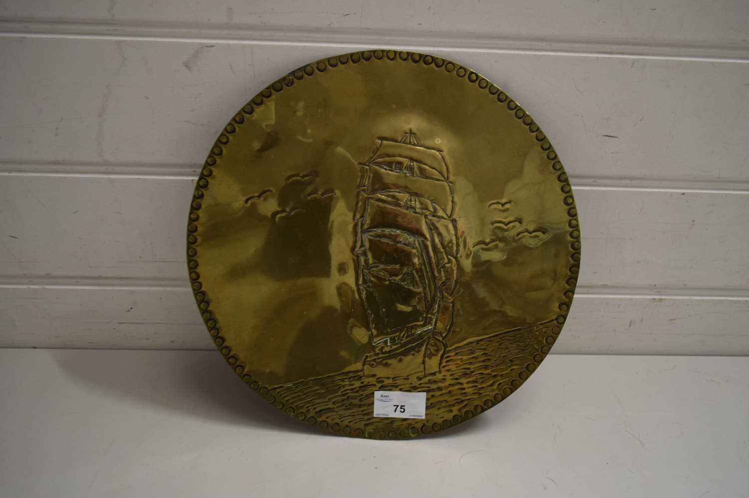 CIRCULAR BRASS WALL PLAQUE DECORATED WITH A TALL SHIP