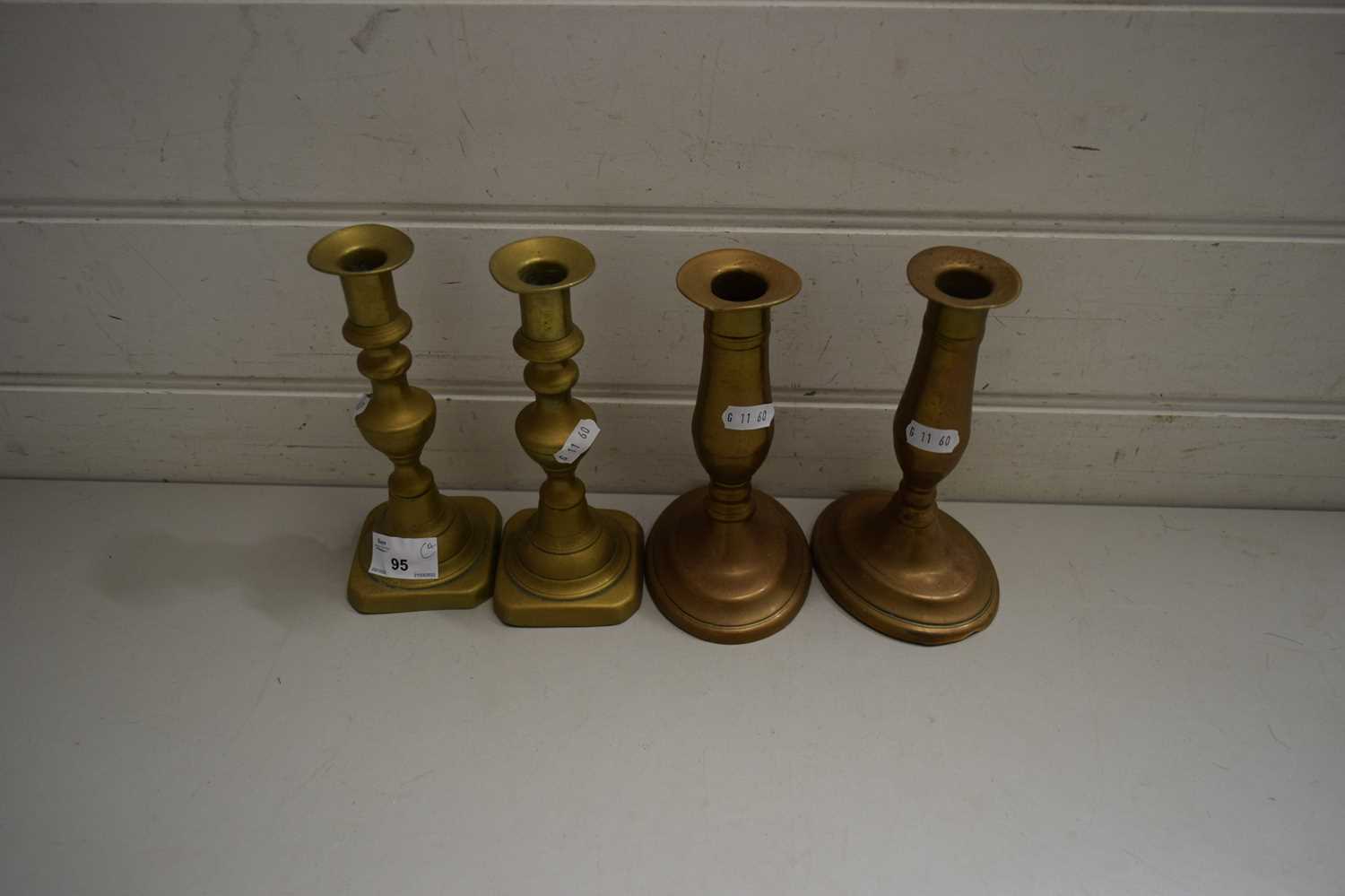 FOUR BRASS CANDLESTICKS