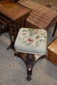 VICTORIAN ROSEWOOD VENEERED PIANO STOOL WITH REVOLVING TOP OVER A THREE FOOTED BASE WITH PAW FEET