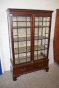 LATE 19TH CENTURY MAHOGANY FRAMED DISPLAY CABINET WITH TWO GLAZED DOORS OVER A CUPBOARD BASE