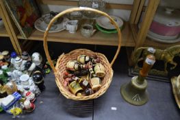 BASKET CONTAINING MINIATURE SPIRIT BOTTLES AND QUANTITY OF BISCUIT TINS