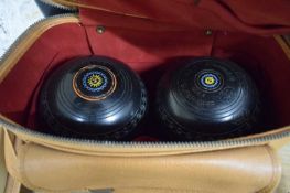 CASE CONTAINING TWO LAWN BOWLS