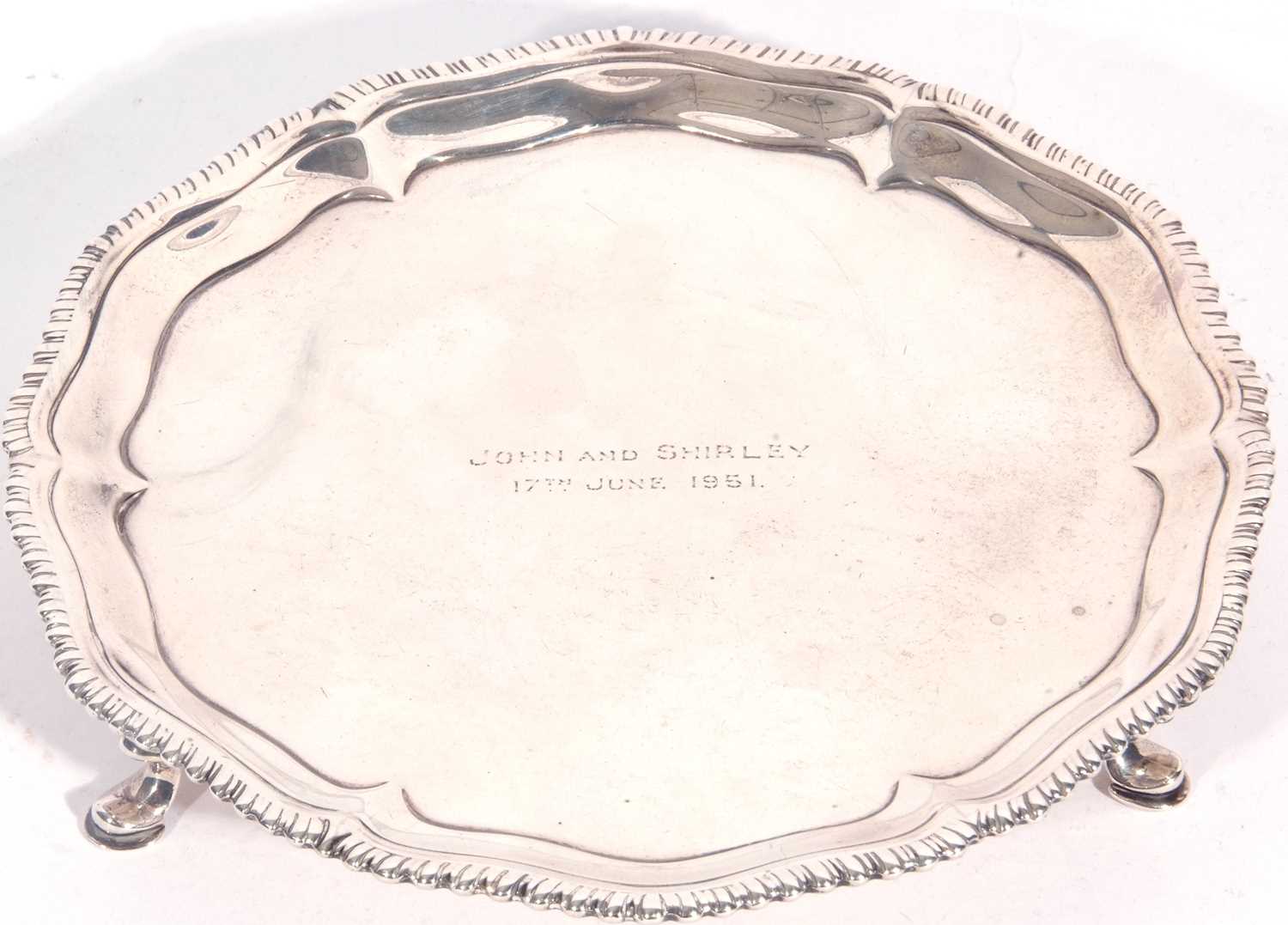 George III silver card salver having a gadrooned edge surrounding a plain design tray, centrally