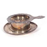 Mixed Lot: hallmarked silver tea strainer, London 1955, together with a George V silver tea strainer