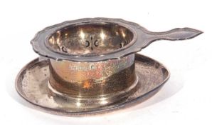 Mixed Lot: hallmarked silver tea strainer, London 1955, together with a George V silver tea strainer