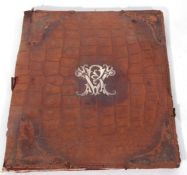 Vintage large leather folder with a central white metal motif, 35 x 28cm (a/f)