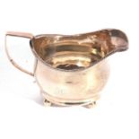 George III silver cream jug of plain form with gadrooned rim, angular looped handle, initialled